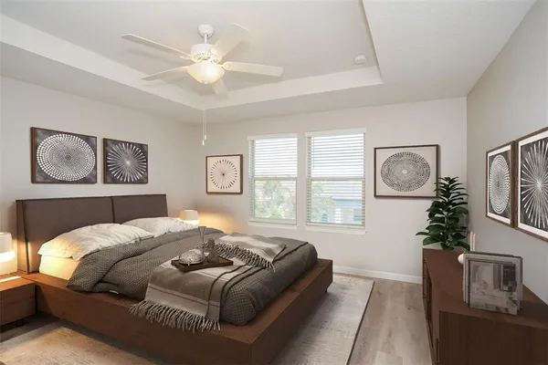 a bedroom with a large bed and a chandelier