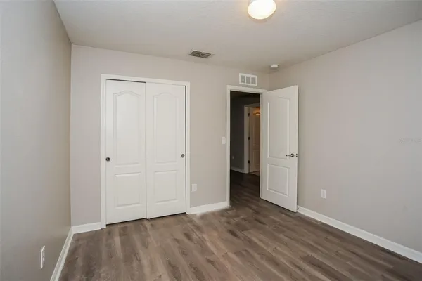 a view of an empty room and wooden floor