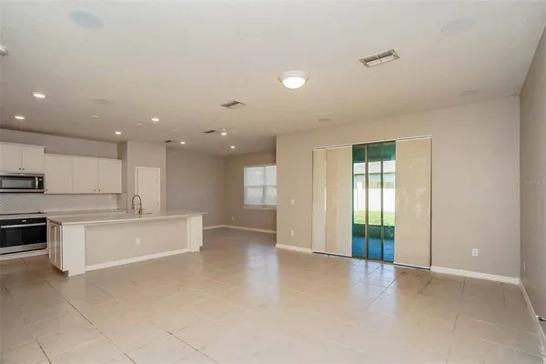 a view of kitchen with stainless steel appliances refrigerator oven and cabinets