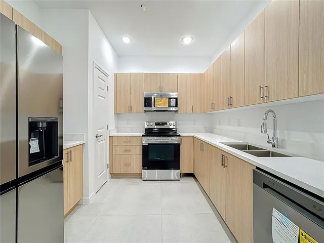 a kitchen with a sink stove and refrigerator