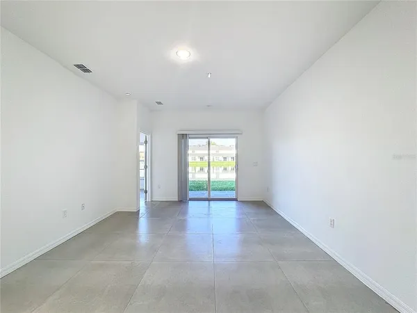 an empty room with entrance and windows