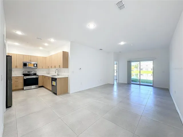a view of a kitchen with a sink and cabinets