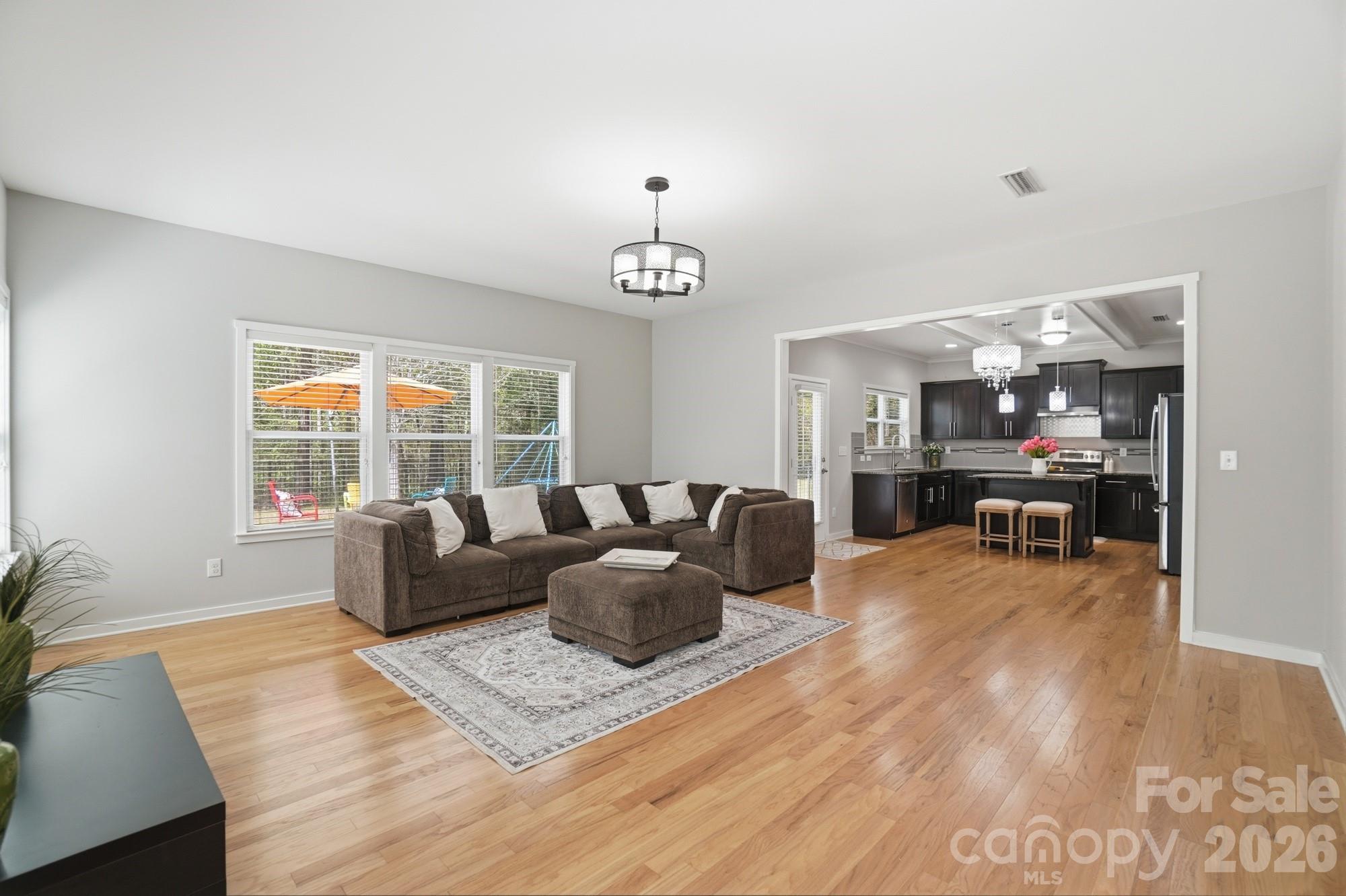 2153 Bluebell Way Tega Cay, SC 29708 - Photo 19 of 48 a living room with furniture and a chandelier
