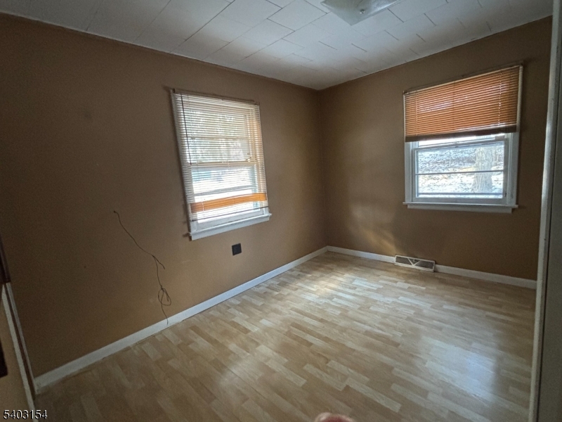 14 Mountain View Trail Wharton, NJ 07885 - Photo 3 of 14 a view of an empty room with wooden floor and a window