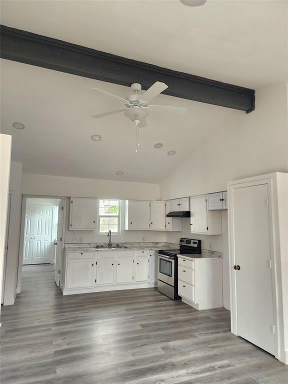 1178 Nob Hill Road Quinlan, TX 75474 - Photo 2 of 13 Kitchen with stainless steel electric range oven, a sink, a ceiling fan, and white cabinets