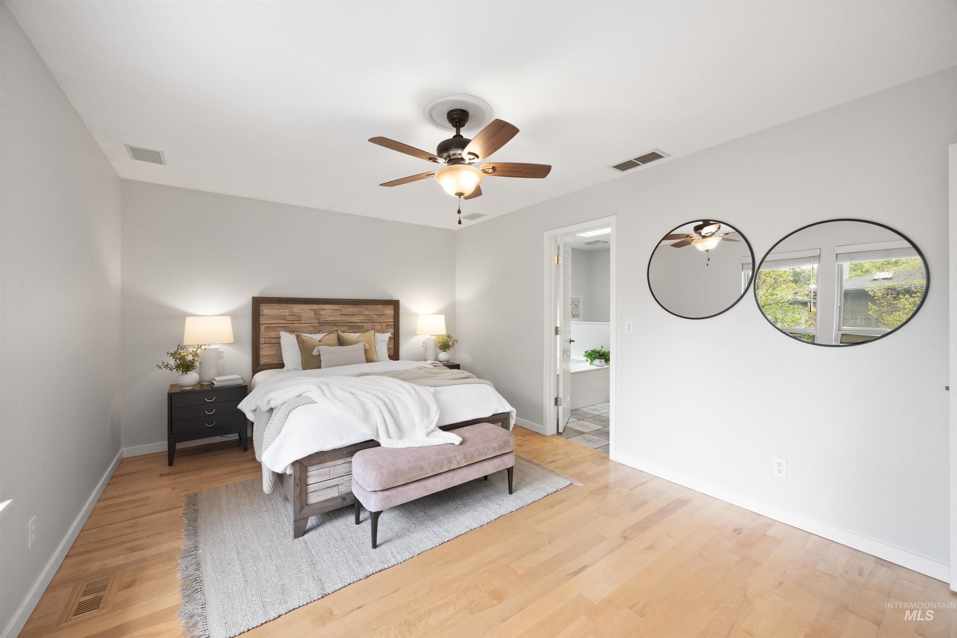 1313 Martin Street Boise, ID 83706 - Photo 11 of 46 Bedroom featuring light wood-type flooring, connected bathroom, and a ceiling fan