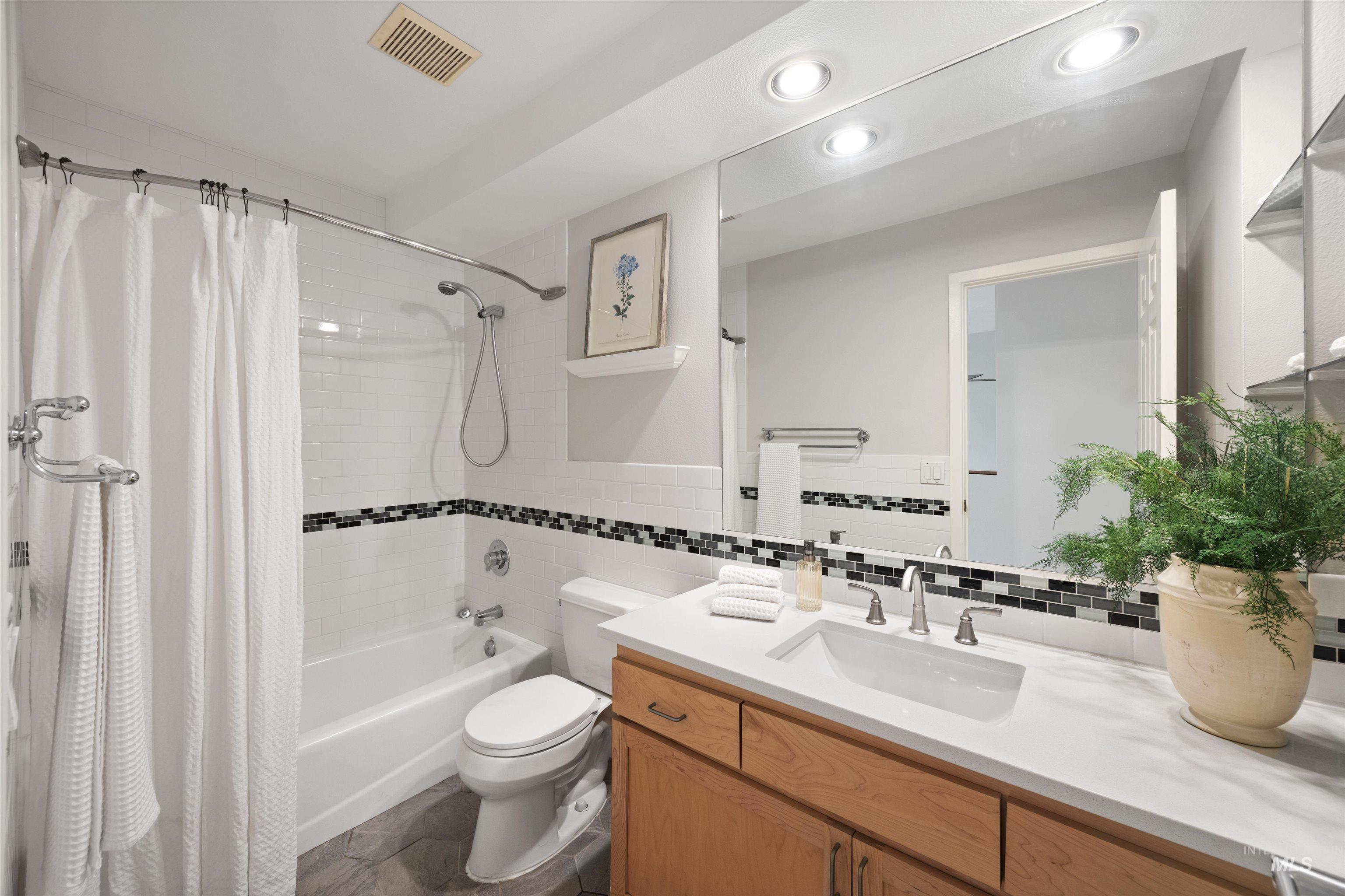 1313 Martin Street Boise, ID 83706 - Photo 14 of 46 Full bath featuring vanity, shower / bath combo, and tile walls