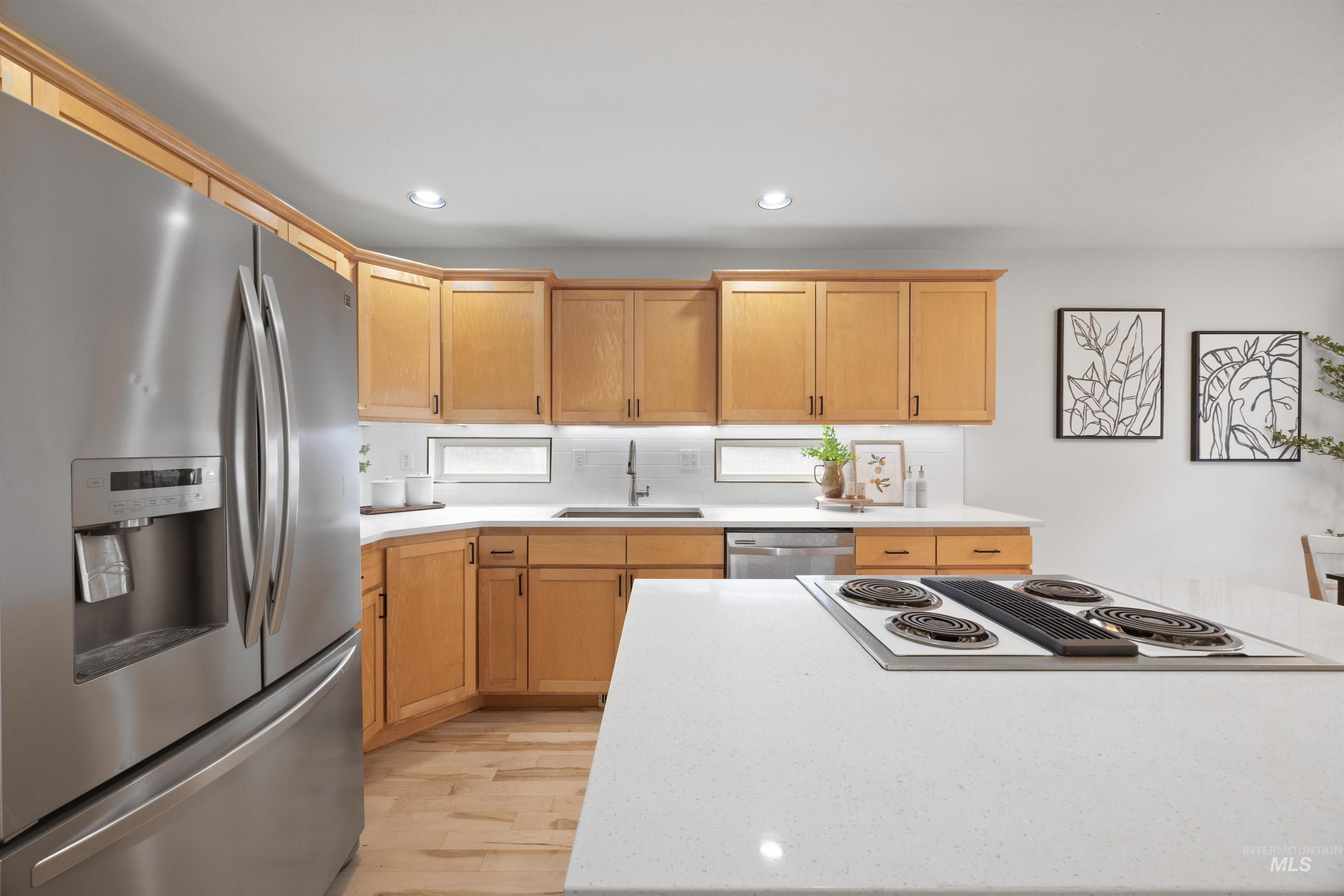 1313 Martin Street Boise, ID 83706 - Photo 28 of 46 Kitchen with stainless steel appliances, light wood-style floors, backsplash, recessed lighting, and light wood finish cabinetry