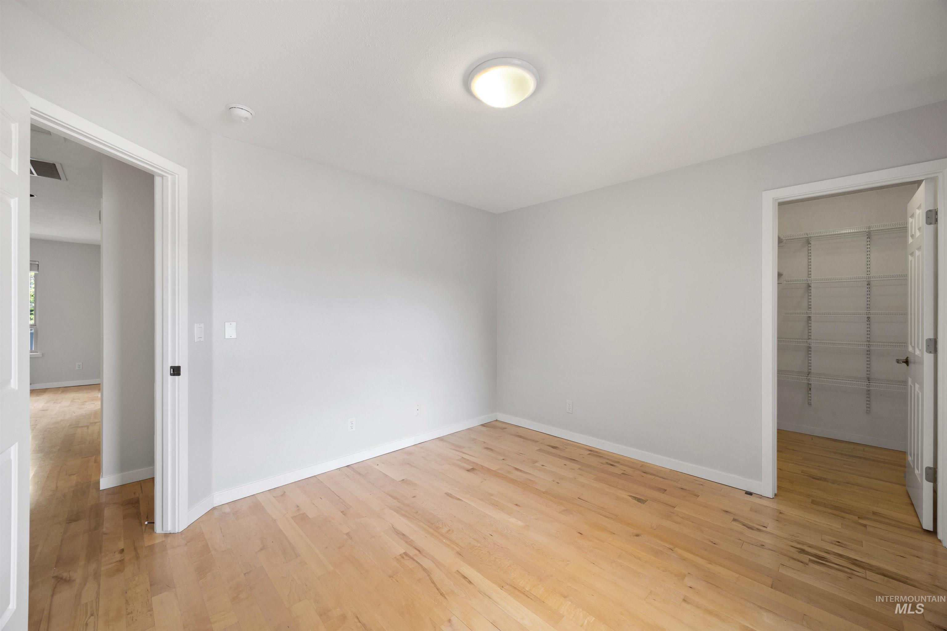 1313 Martin Street Boise, ID 83706 - Photo 45 of 46 Unfurnished bedroom with light wood-style flooring and a spacious closet