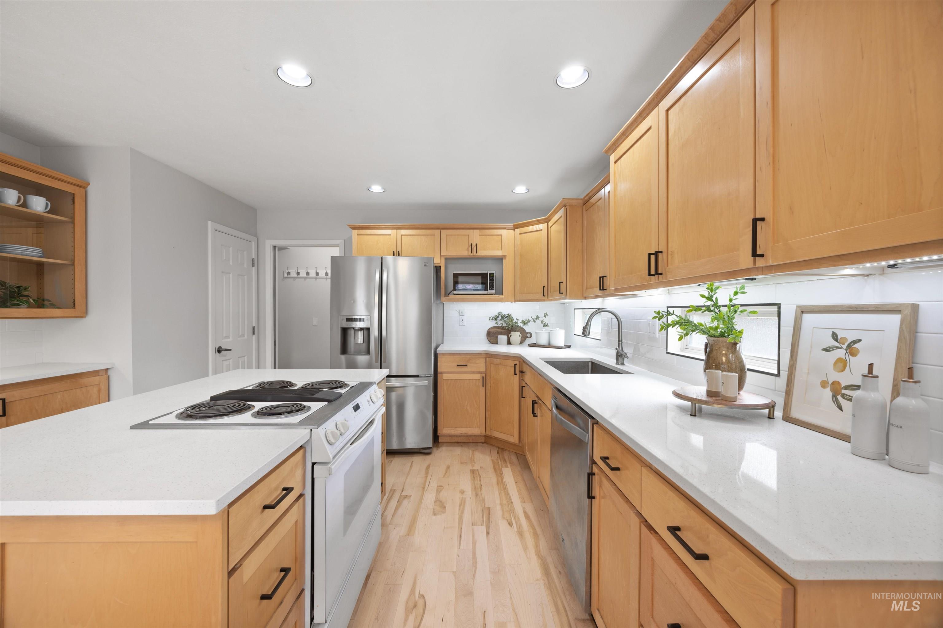 1313 Martin Street Boise, ID 83706 - Photo 6 of 46 Kitchen featuring stainless steel appliances, light wood-style flooring, recessed lighting, light wood finish cabinetry, and a center island