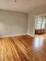 34 Averton Street, Unit 1 Boston, MA 02131 - Photo 1 of 16 a view of empty room with wooden floor and fan