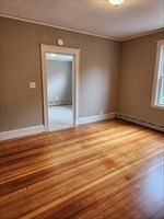 34 Averton Street, Unit 1 Boston, MA 02131 - Photo 11 of 16 an empty room with wooden floor and windows