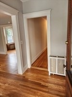 34 Averton Street, Unit 1 Boston, MA 02131 - Photo 14 of 16 a view of a hallway with wooden floor and dining room