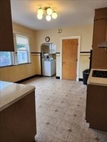 34 Averton Street, Unit 1 Boston, MA 02131 - Photo 5 of 16 a kitchen with a refrigerator and a stove top oven