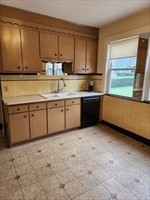 34 Averton Street, Unit 1 Boston, MA 02131 - Photo 6 of 16 a kitchen with stainless steel appliances granite countertop a sink and a stove top oven