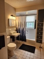 34 Averton Street, Unit 1 Boston, MA 02131 - Photo 9 of 16 a bathroom with a sink a toilet and shower
