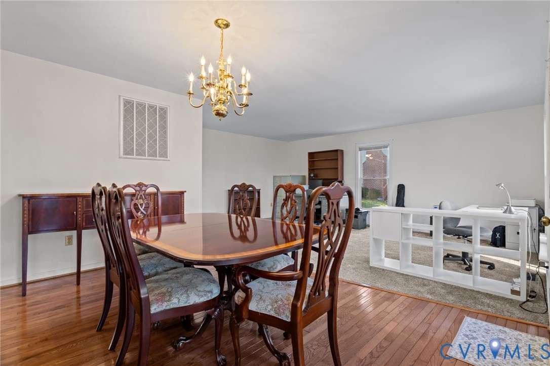 518 Rebel Ridge Road Colonial Heights, VA 23834 - Photo 24 of 44 a view of a dining room with furniture a chandelier and wooden floor