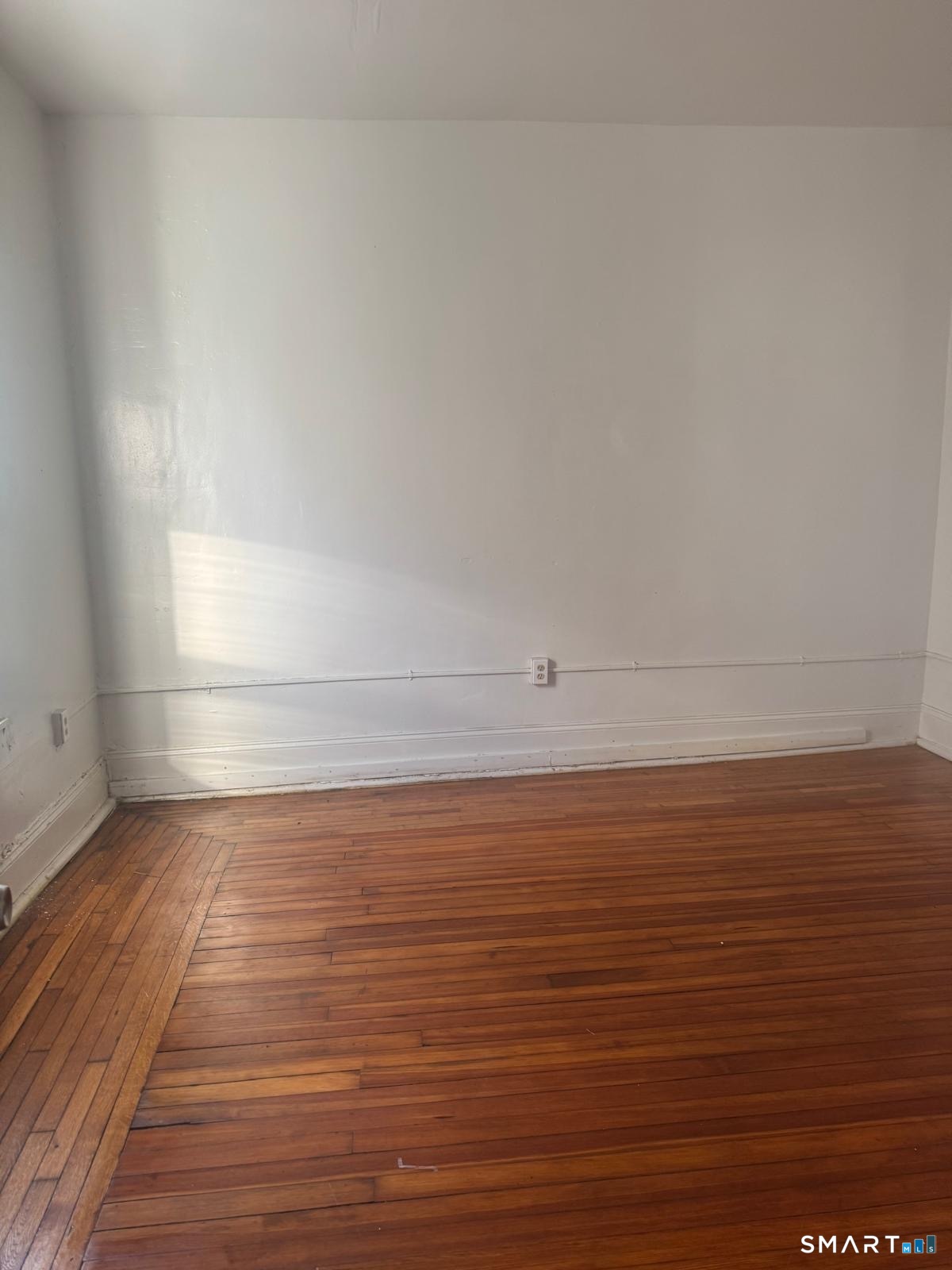 240 William Street, Unit 2B Bridgeport, CT 06608 - Photo 2 of 2 a view of a room with an empty space and wooden floor