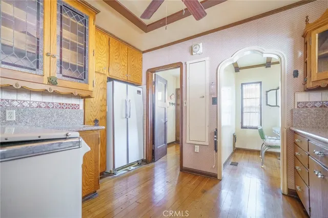 a view of an entryway with wooden floor and a livingroom