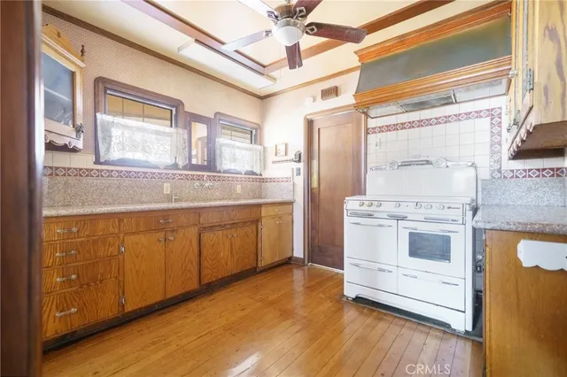 a kitchen with stainless steel appliances granite countertop a stove and a refrigerator