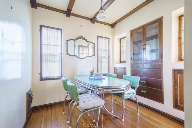 a dining room with furniture and wooden floor