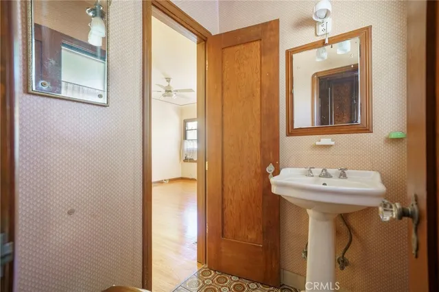 a bathroom with a sink a mirror and a window