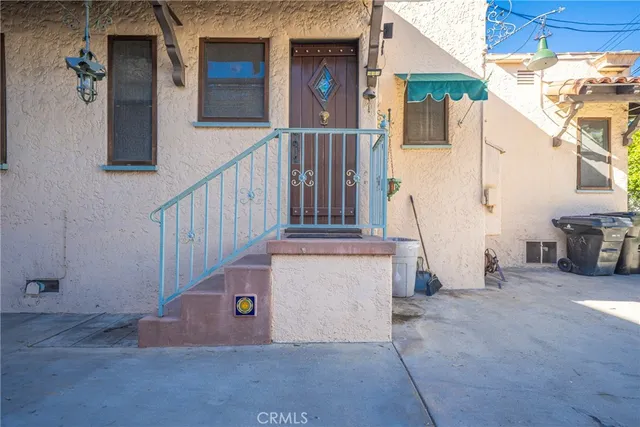 a view of front door of house with stairs