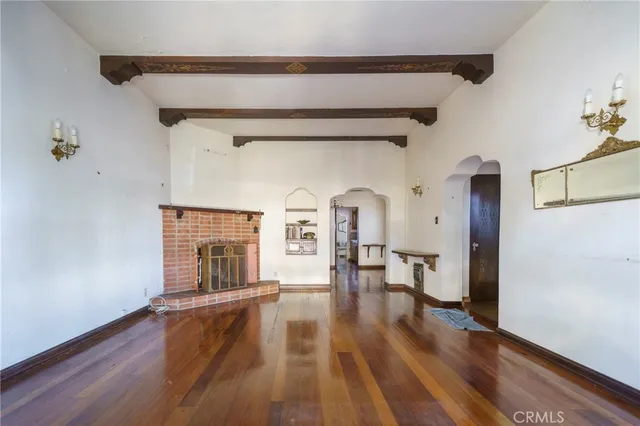 wooden floor fireplace and natural light in room