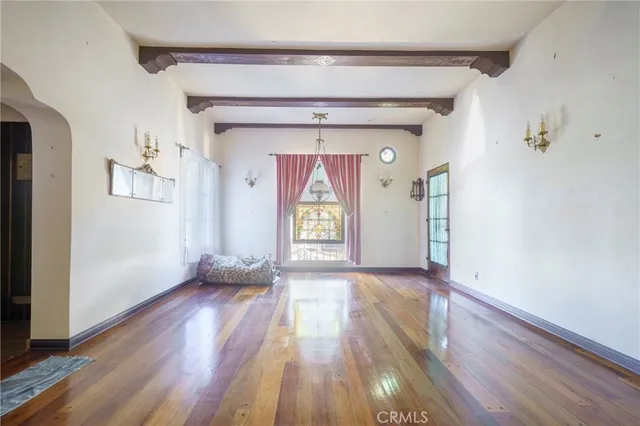 wooden floor in an empty room with a window