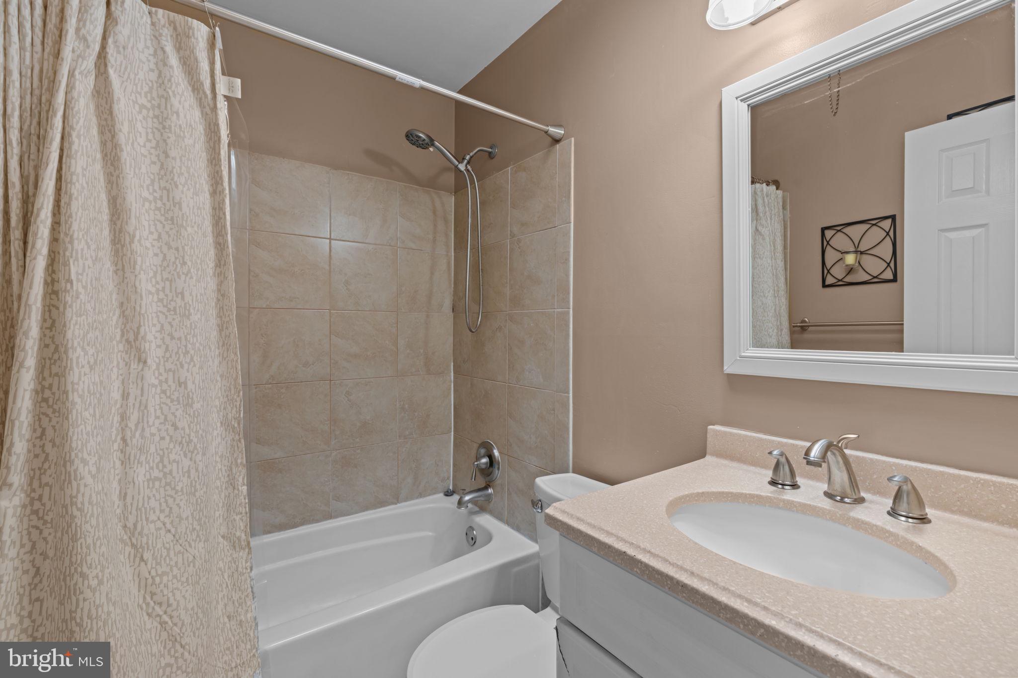 13039 Stevens Road Philadelphia, PA 19116 - Photo 12 of 32 a bathroom with a granite countertop sink toilet and shower