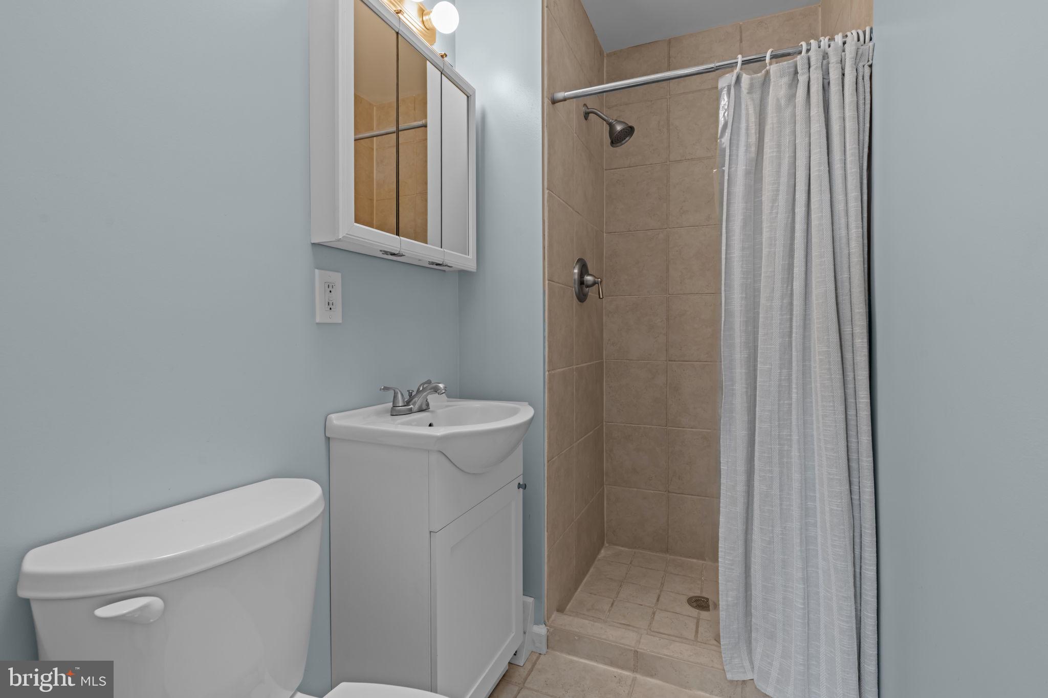 13039 Stevens Road Philadelphia, PA 19116 - Photo 15 of 32 a bathroom with a sink a toilet and shower