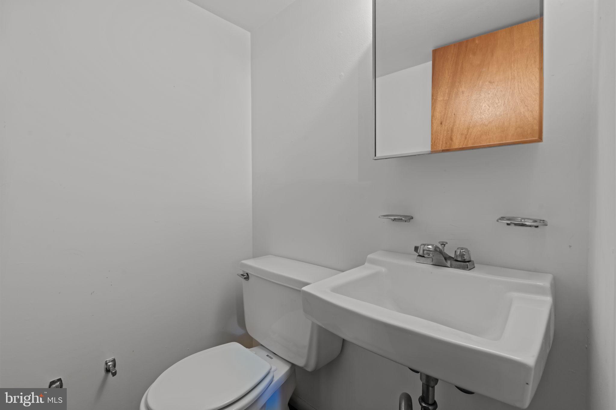 13039 Stevens Road Philadelphia, PA 19116 - Photo 20 of 32 a bathroom with a toilet a sink and mirror