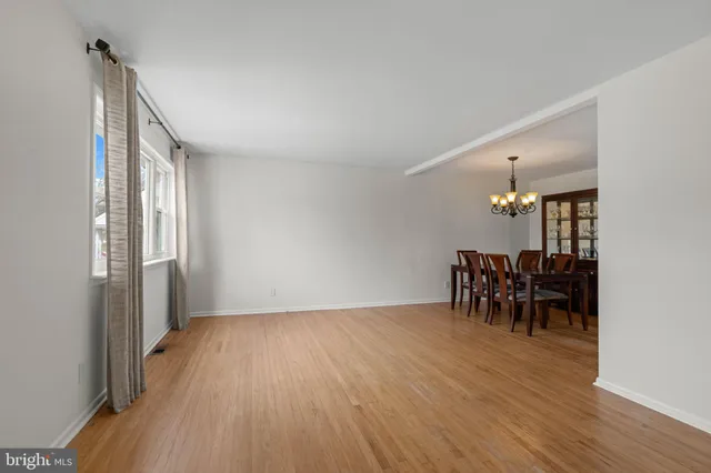 a view of a room with furniture and wooden floor