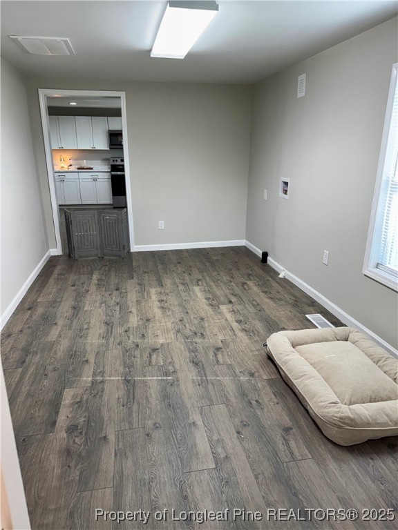 1283 Bethel Baptist Road Spring Lake, NC 28390 - Photo 13 of 44 a view of a livingroom with wooden floor and staircase