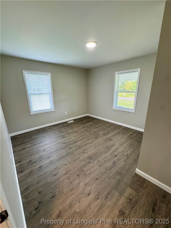 1283 Bethel Baptist Road Spring Lake, NC 28390 - Photo 25 of 44 an empty room with wooden floor and windows