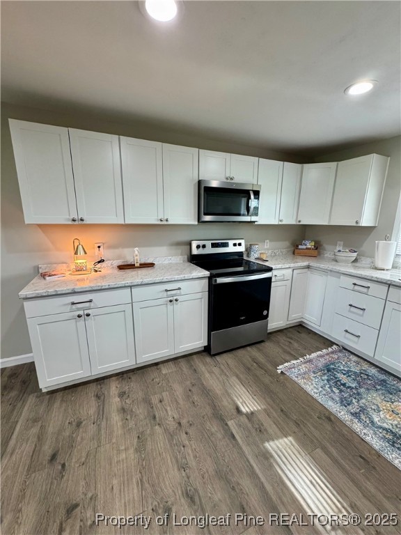 1283 Bethel Baptist Road Spring Lake, NC 28390 - Photo 5 of 44 a kitchen with stainless steel appliances granite countertop a stove a sink dishwasher and a refrigerator