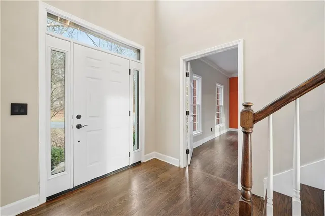 a view of an entryway with wooden floor
