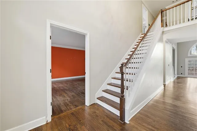 a view of entryway and hall with wooden floor
