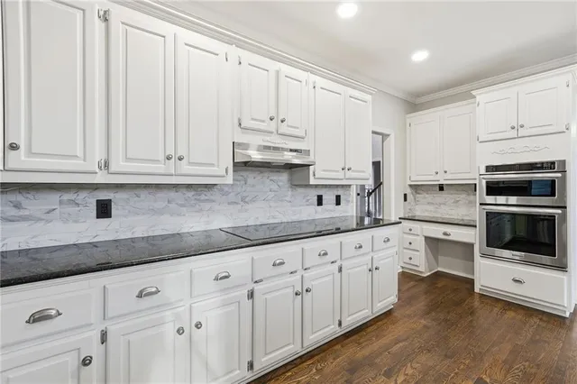 a kitchen with white cabinets and white appliances