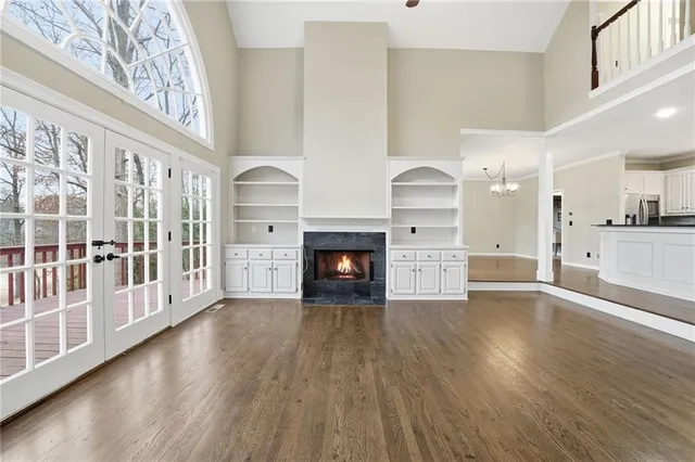 a view of a livingroom with wooden floor and a fireplace