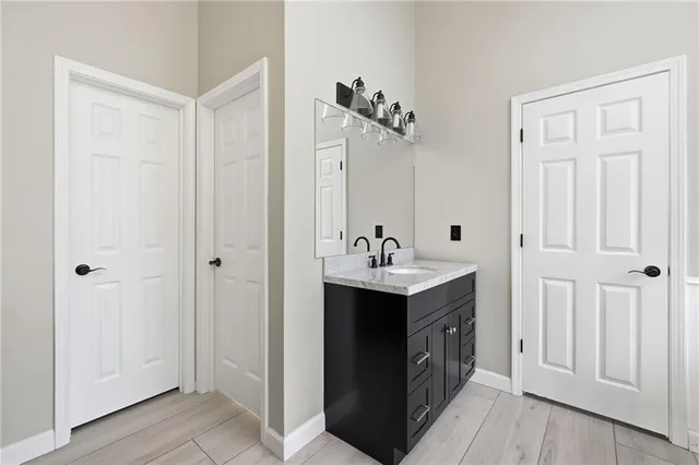 a bathroom with a double vanity sink a mirror and a shower
