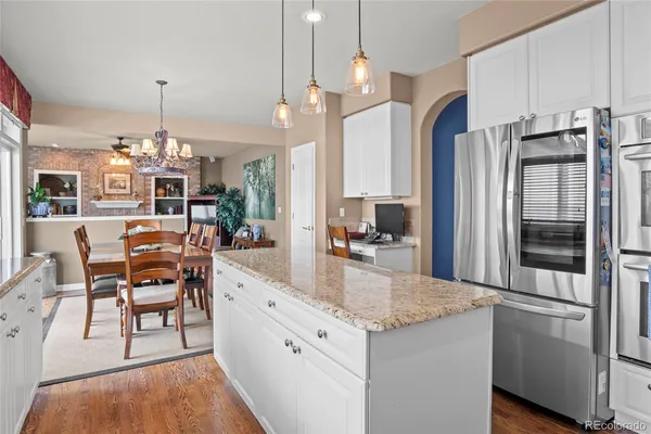 a kitchen with granite countertop a stove oven and refrigerator