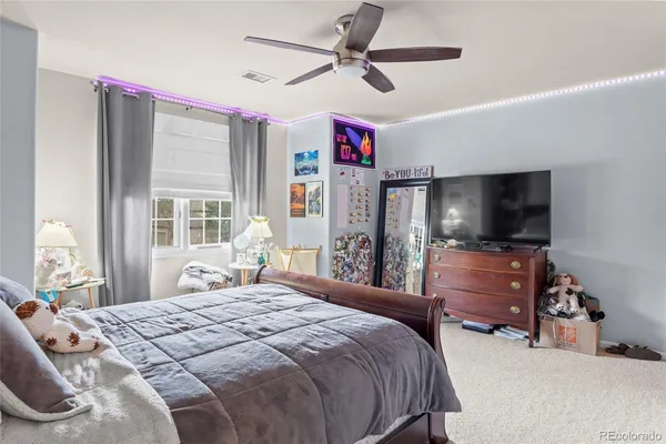 a bedroom with a bed and a chandelier