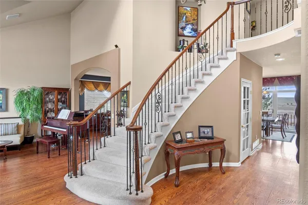 a view of entryway and hall with wooden floor