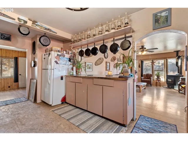 a kitchen with a sink a stove a dining table and chairs