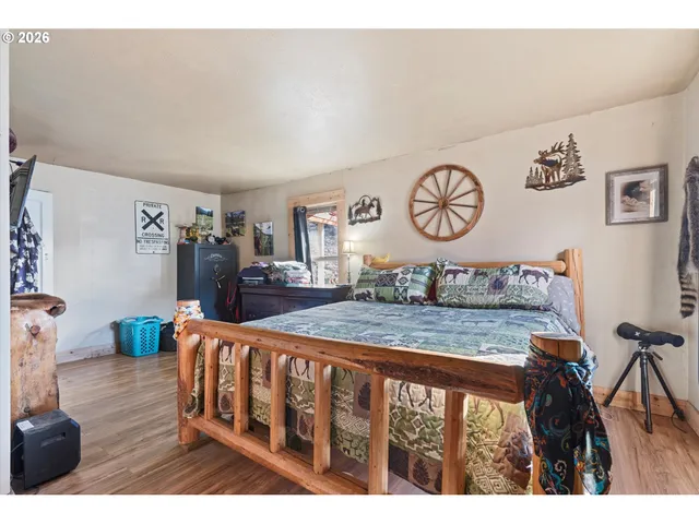 a view of a hallway with wooden floor and stairs