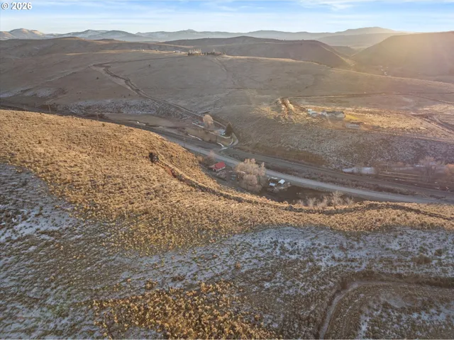 a view of a cafe with a table and chairs under an umbrella