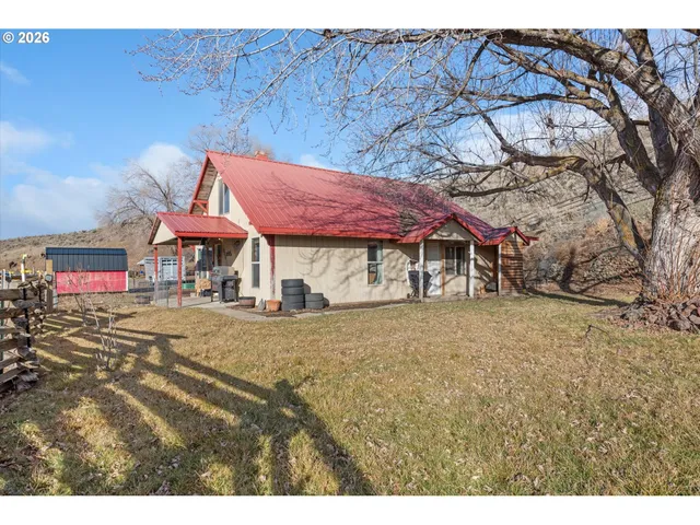 a view of a house with a wooden fence