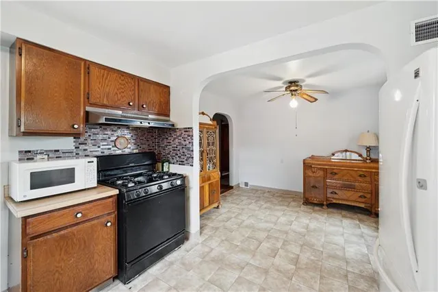 a kitchen with a stove and a refrigerator