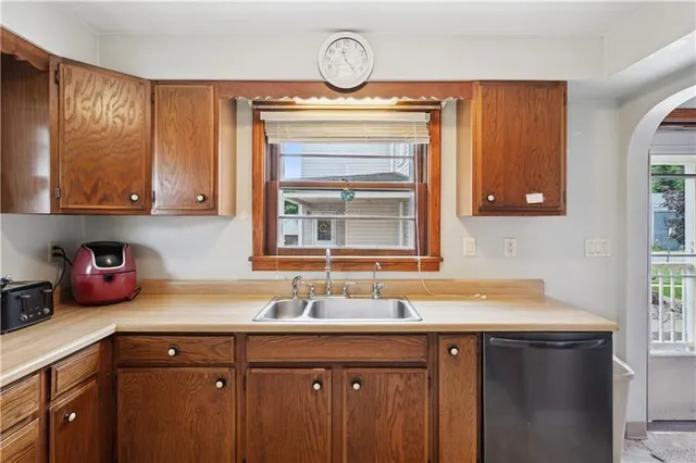 a sink a stove a mirror and cabinets